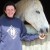 Kay Alty New Yatt RDA Kay Alty of New Yatt Riding for the Disabled Association, giving a treat to a fleabitten grey horse