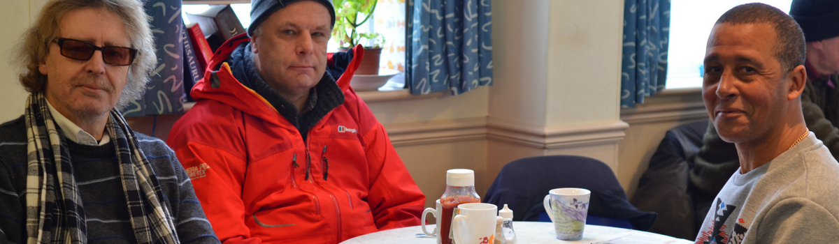 Homeless men having tea