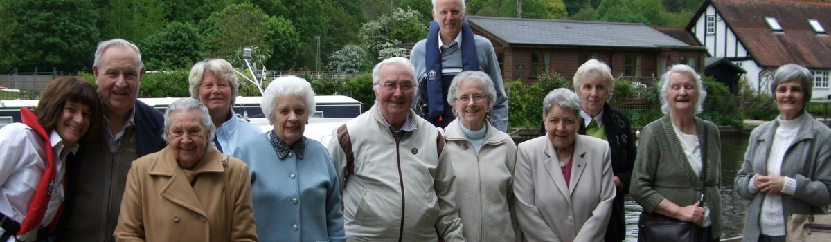 Older people on a day trip by a canal