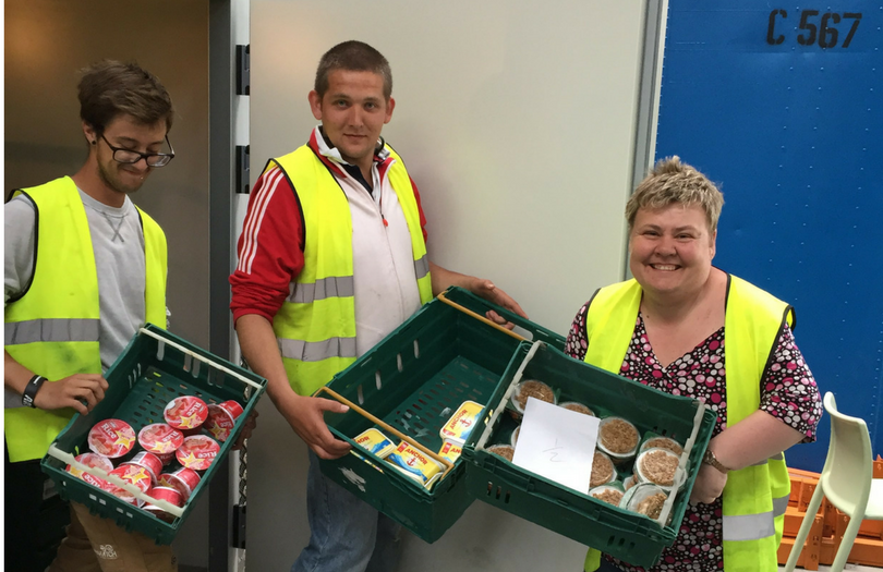 Young people carrying food in the SOFEA warehouse