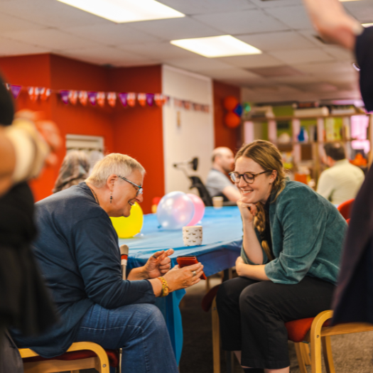 Community Building Energy support grants 810 x 525 Picture of an older lady chatting in a community centre. New grants to help community groups with their energy bill costs funded by Oxfordshire County Council.