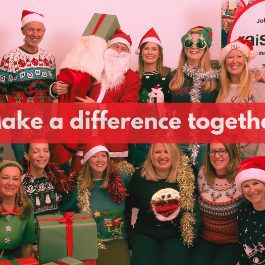 People are dressed up in Christmas outfits, standing next to a Christmas tree
