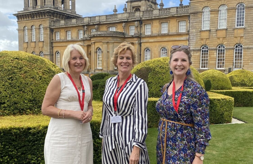 Heather Carter of Blenheim Palace, Della Wolfe (chair of the football panel), and OCF's Kate Parrinder stand in front of the palace