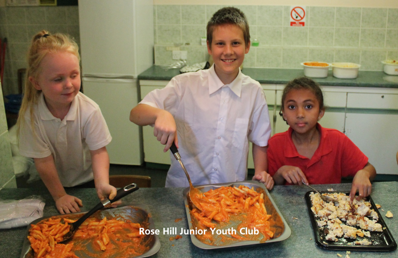 Three children cooking food