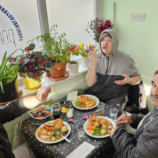 Feoffees news story 800×525 Three men are sitting around a table eating a roast dinner at The Porch.