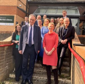 A group of people standing on some steps and smiling.