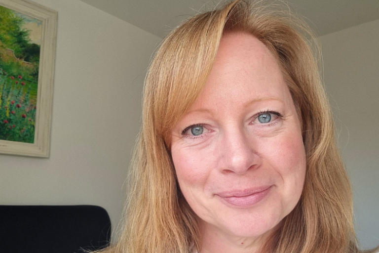 Naomi Lyons smiling at the camera.