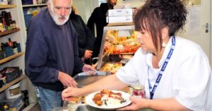 A man being served a plate of food.